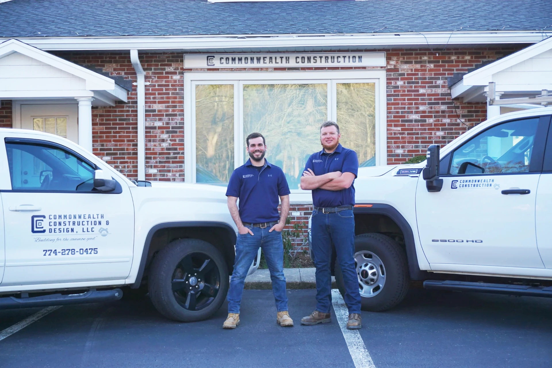 Commonwealth Construction & Design team in front of their Wrentham, MA office and work trucks
